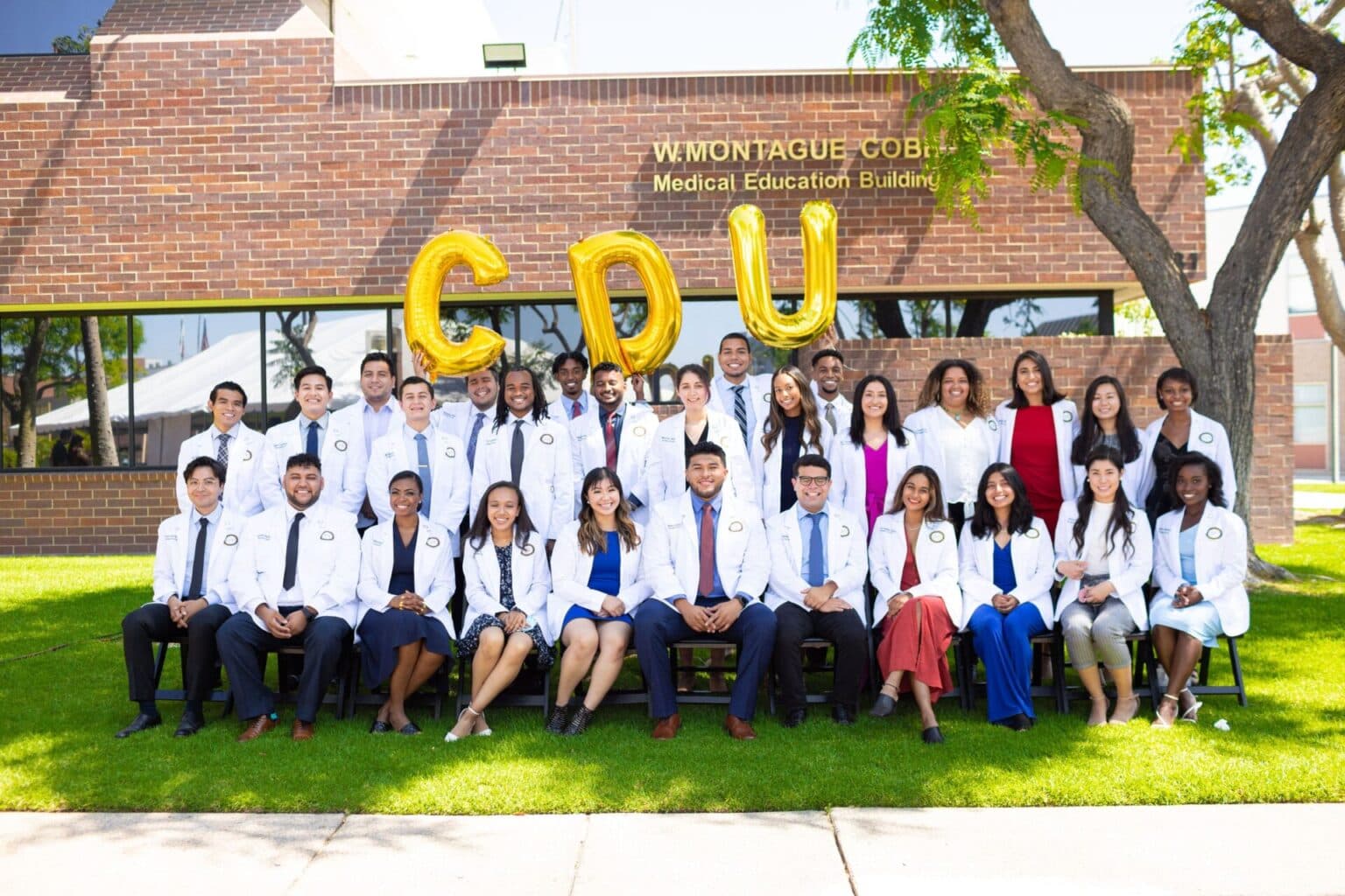 Medical grads group photo at event.