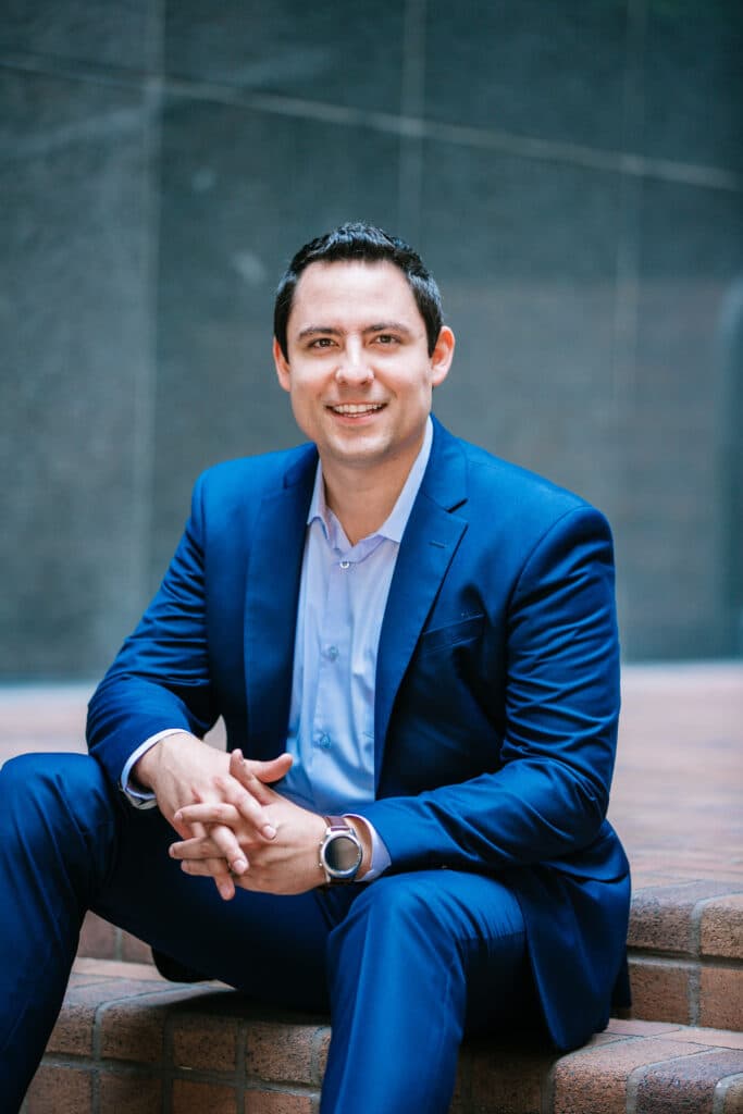 Professional man in blue suit outdoor portrait for corporate branding.