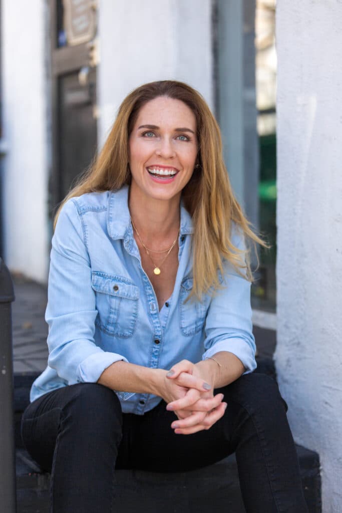Casual portrait of woman smiling outdoors, ideal for a professional headshot.