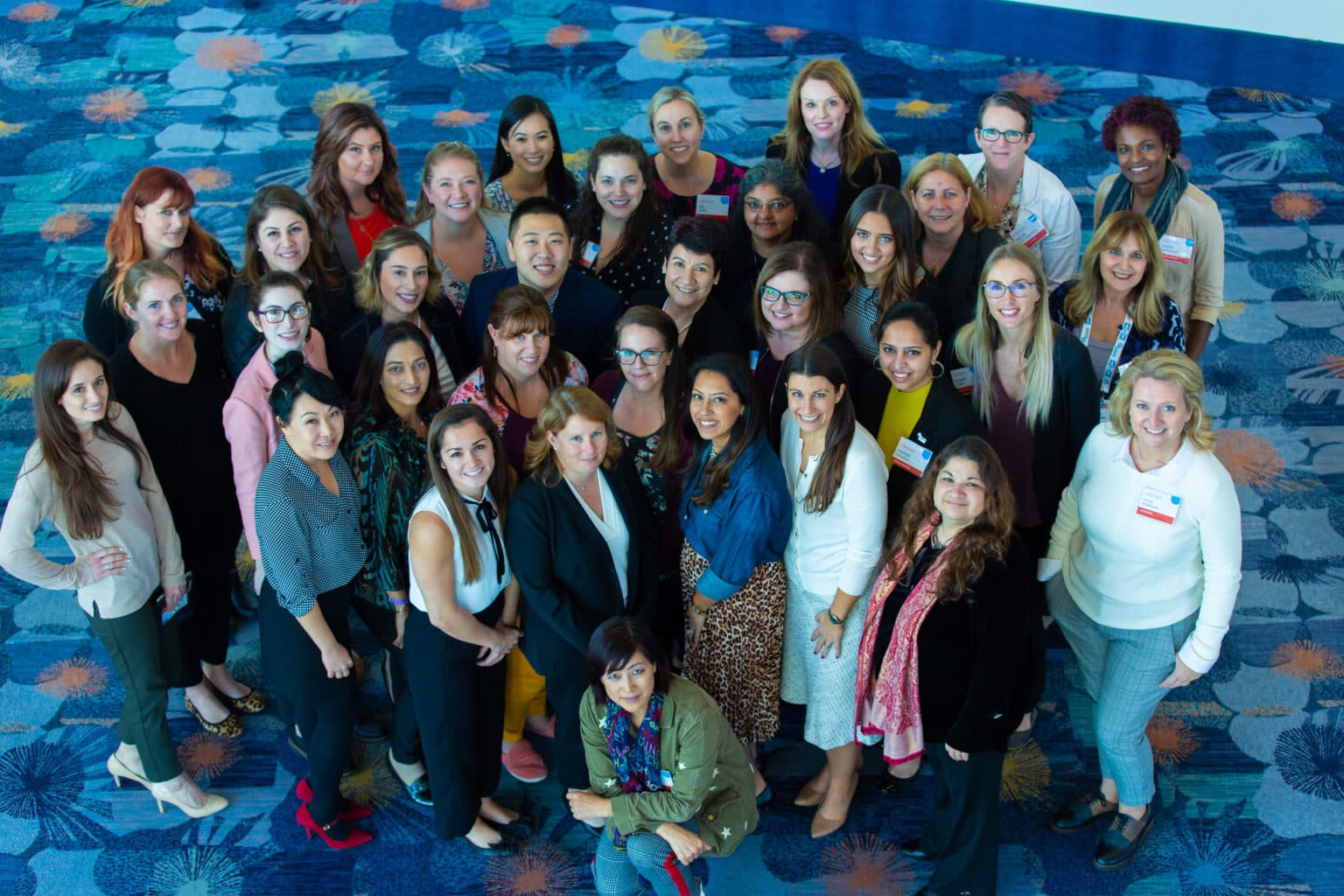 Group of diverse professionals smiling at a corporate event, overhead shot.